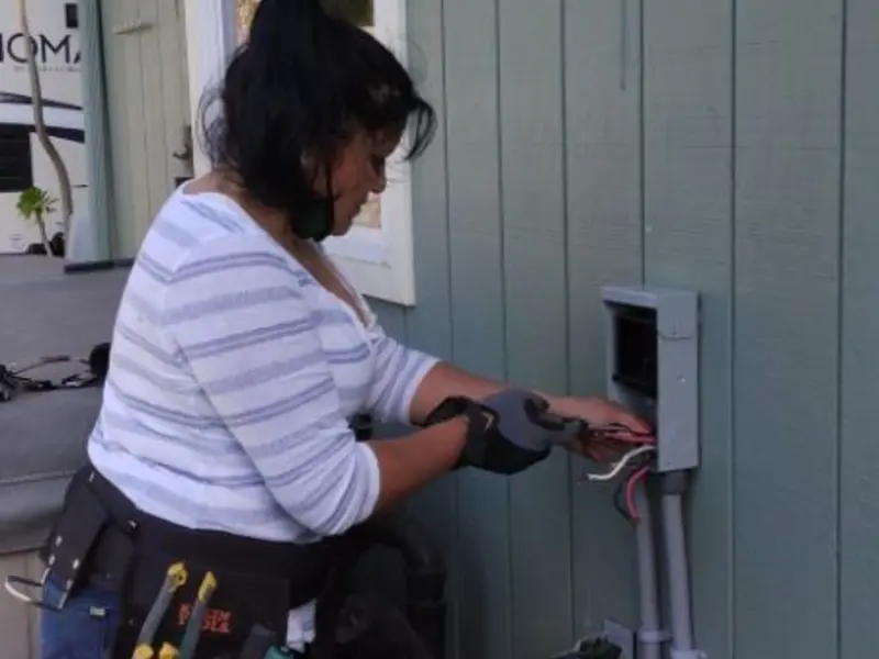 Licensed electrician wiring an exterior subpanel in Alexander City